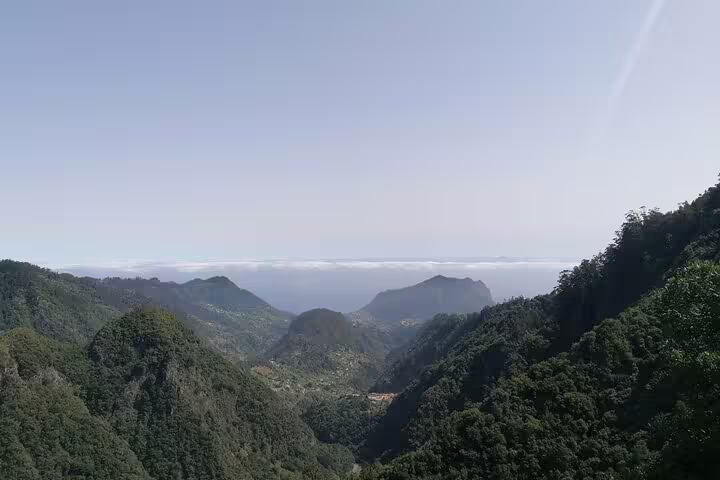 Breathtaking panoramic view of lush green valleys and distant mountains in Ribeiro Frio, ideal for nature tours.