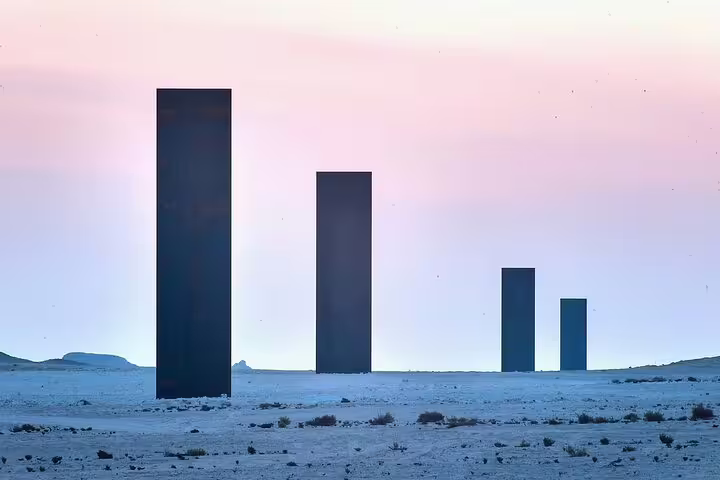 Stunning view of Richard Serra's towering sculptures at sunset in the Zekreet desert, perfect for a West Coast tour.