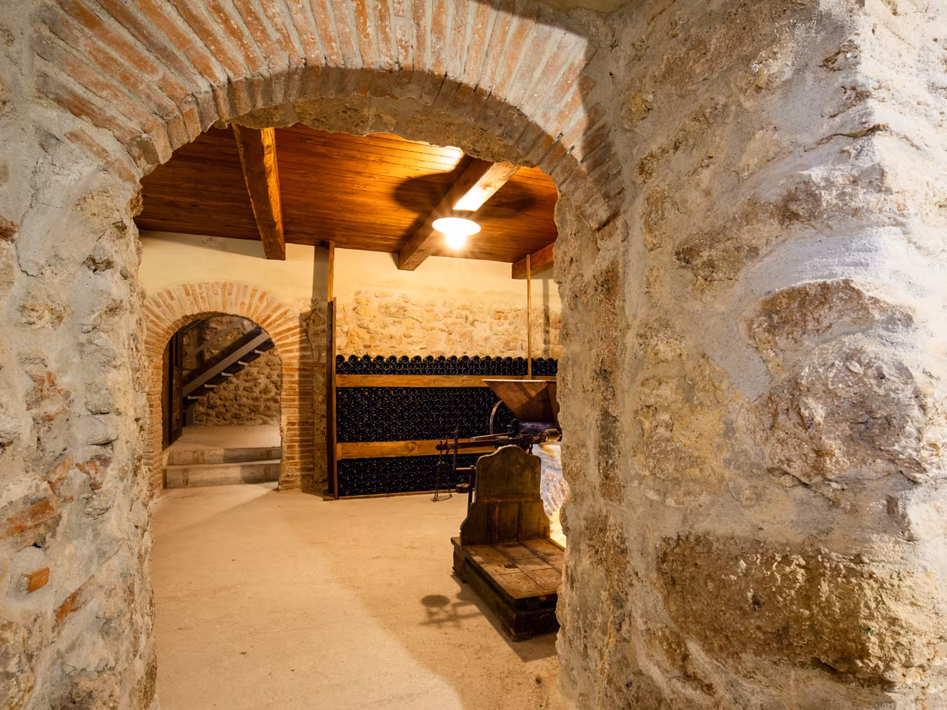 Stone archway leading to a traditional wine cellar in Rieti countryside.