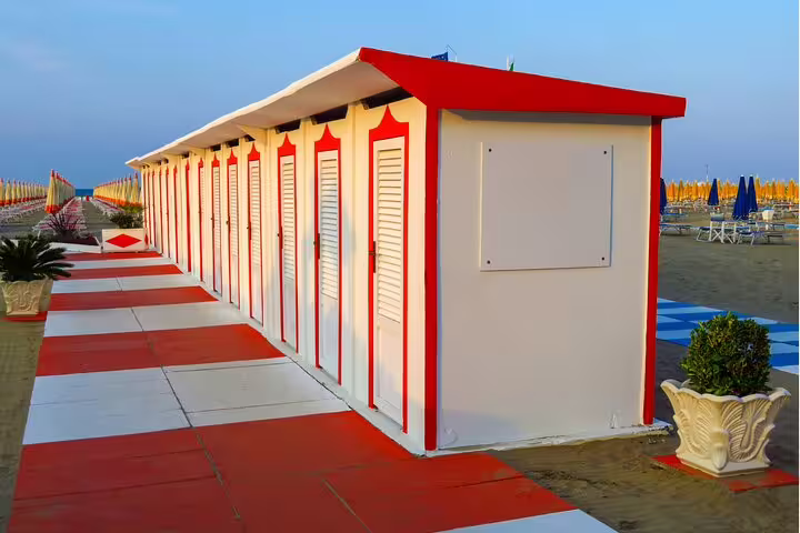 Colorful beach cabins on Rimini seafront promenade, perfect stop on a self-guided scavenger hunt tour
