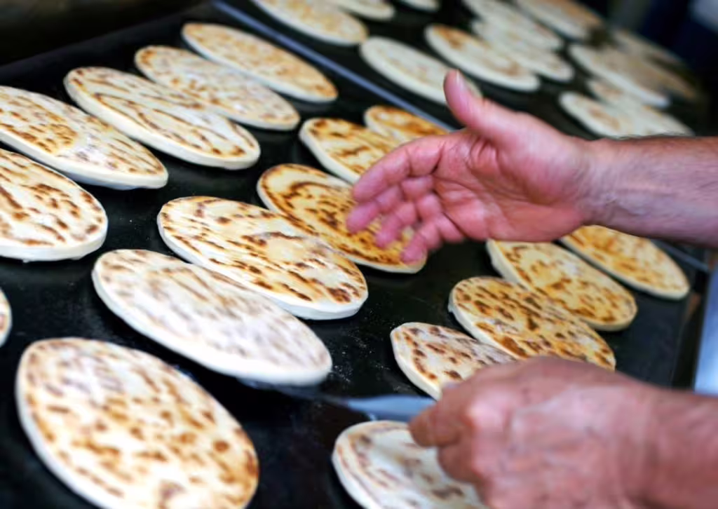 Fresh piadina flatbreads cooking on a hot griddle during Rimini Piadina Museum tour and tasting experience