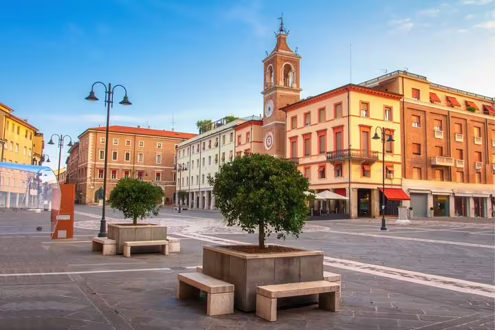 Piazza Tre Martiri in Rimini with clock tower and cafes, key landmark on a self-guided scavenger hunt tour
