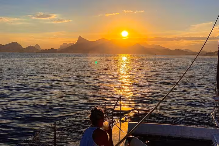 Sunset view from catamaran deck in Rio de Janeiro on Velas do Rio 5-hour private sailing tour with open bar