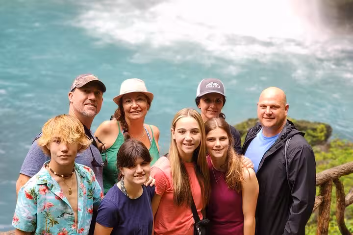 Group enjoying the scenic view of Rio Celeste waterfall during a full day hiking tour.