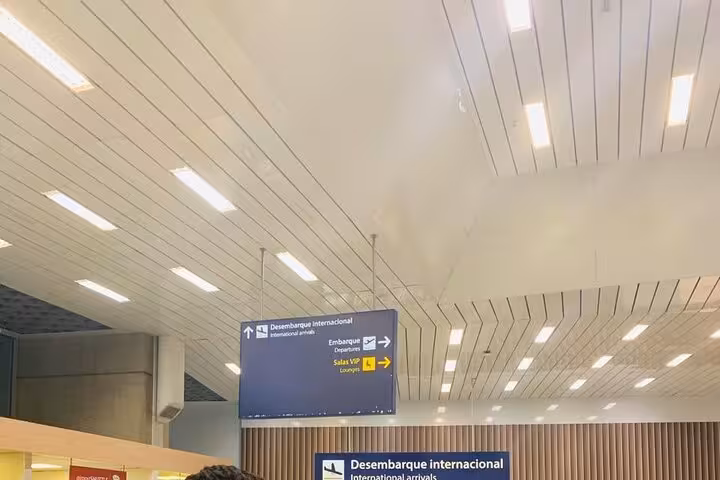 Interior view of Rio de Janeiro airport's international arrivals with clear signage for passenger convenience.