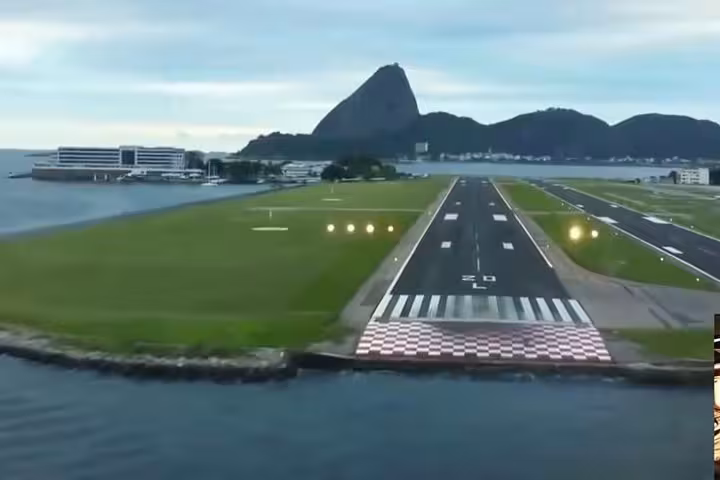 Aerial view of Rio de Janeiro's Santos Dumont Airport runway with Sugarloaf Mountain in the background, ideal for Paraty shuttle.