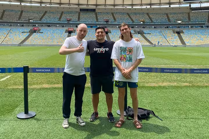 Visitors posing by the field on a Rio de Janeiro Maracanã Stadium tour with local guide experience