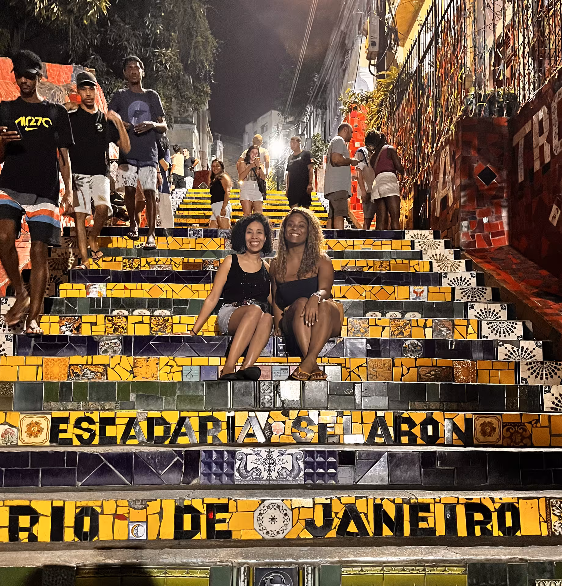Guests on Rio de Janeiro historical city centre pedicab tour at colorful Selarón Steps in Lapa at night