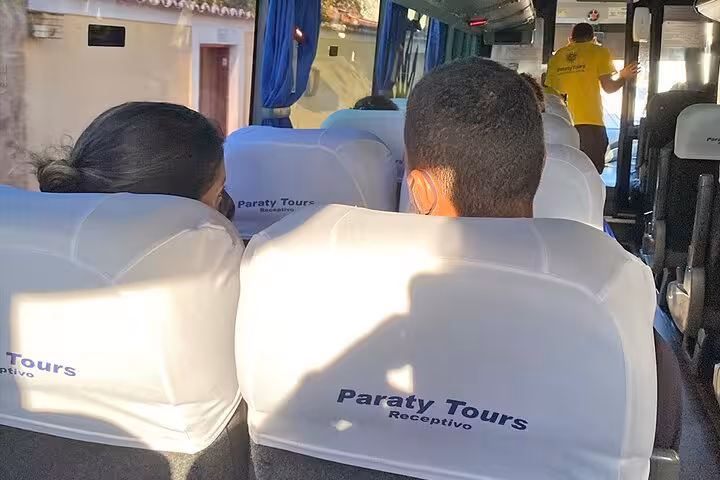 Passengers seated inside Paraty Tours shuttle bus, enjoying comfortable transport from Rio de Janeiro to Angra dos Reis.