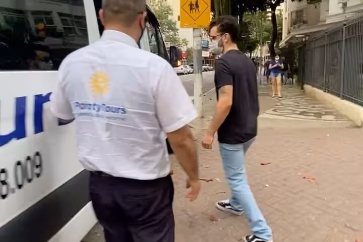Traveler boarding a shuttle van in Rio de Janeiro for a convenient transfer to the beautiful Ilha Grande.