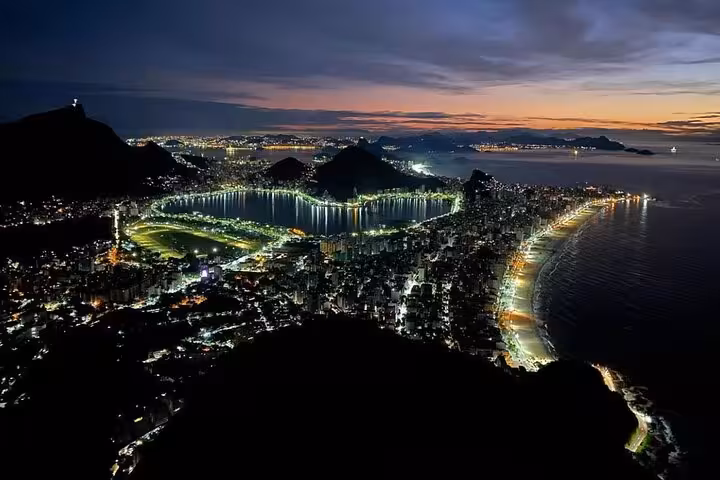 Stunning aerial view of Rio de Janeiro at sunrise, highlighting the vibrant cityscape and coastline.