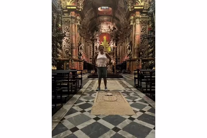 Tourist exploring an ornate church interior in Rio's downtown, featuring rich historical and religious landmarks.