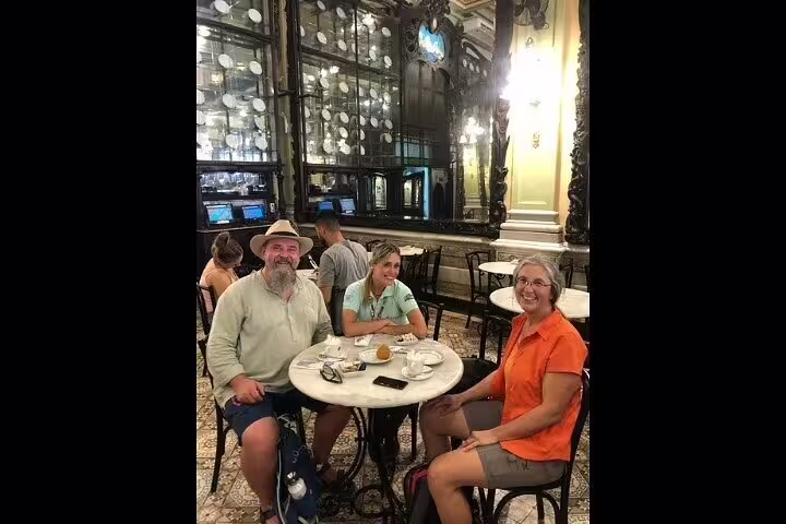 Visitors enjoying coffee at a historic café in Rio's downtown, highlighting cultural stops on the walking tour.