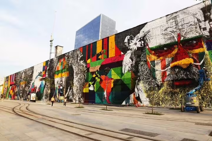 Vibrant mural featuring indigenous faces adorns a wall in Rio's downtown, showcasing artistic culture and history.