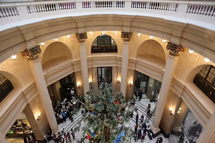 Aerial view of a bustling neoclassical building lobby with columns, capturing Rio's vibrant cultural hub.