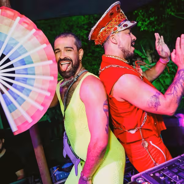 Vibrant Rio Gay Nightlife with dancers in colorful outfits enjoying Samba beats.
