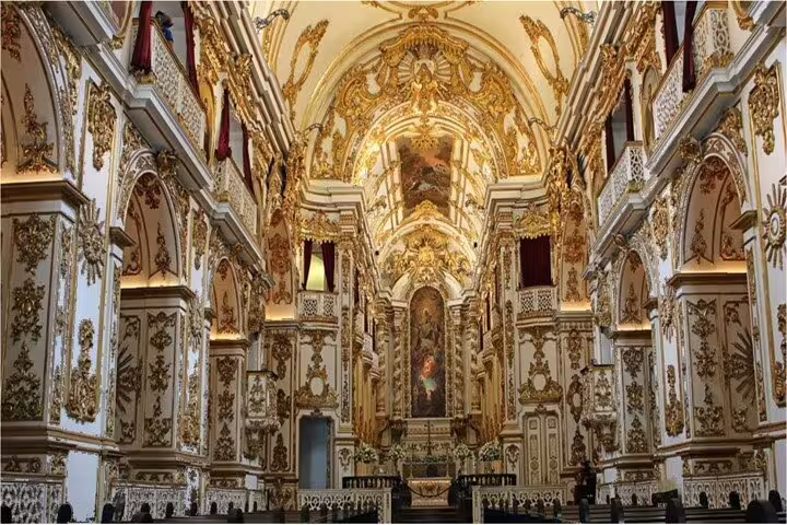 Opulent interior of a historic church in Rio, adorned with gold details, a highlight of the Downtown Walking Tour.