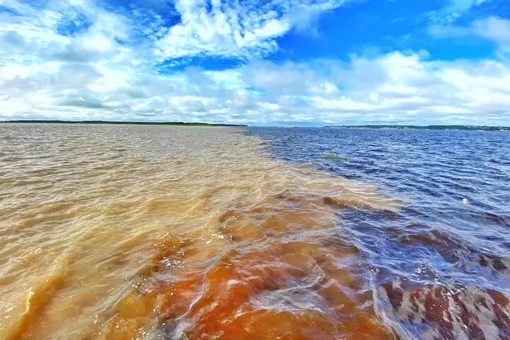 Stunning confluence of the Rio Negro and Amazon River near Tapiri Rio Negro Lodge with distinct water colors.
