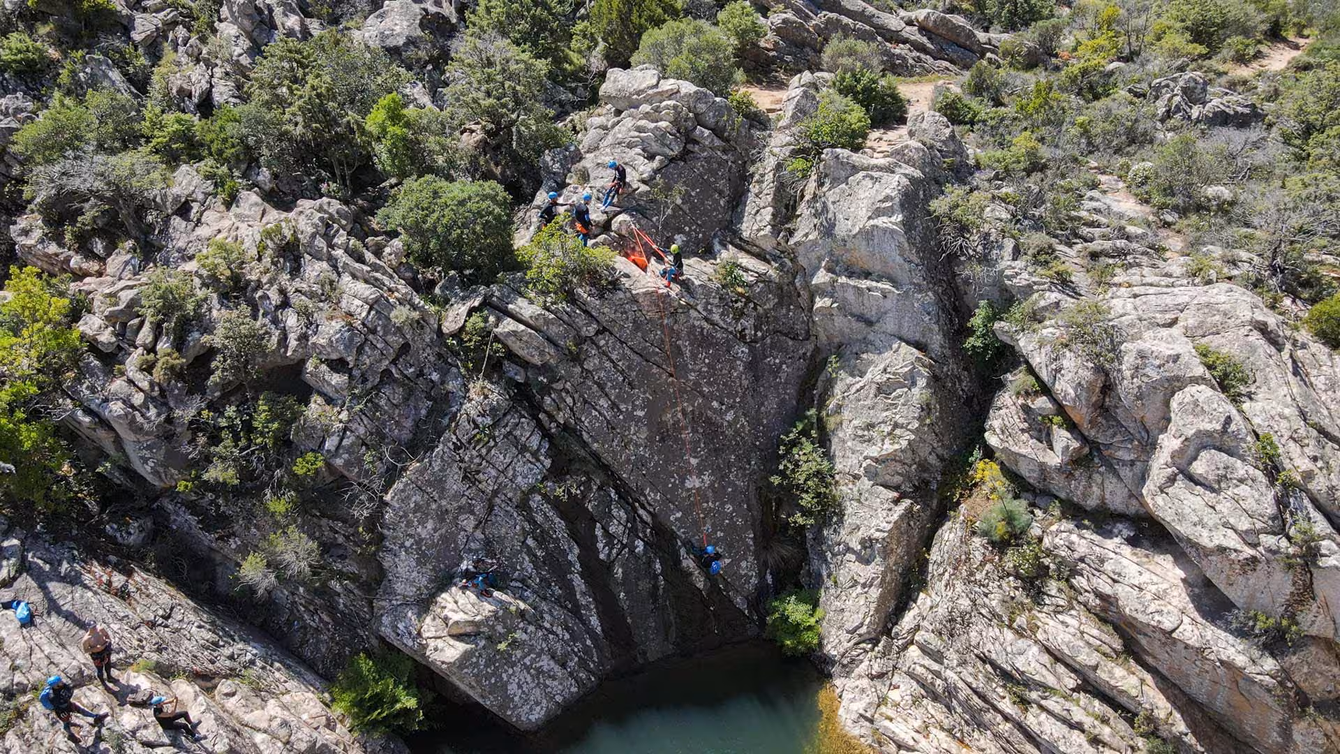 Aerial view of Rio Pitrisconi canyoning adventure, showcasing climbers navigating rocky terrain in San Teodoro.