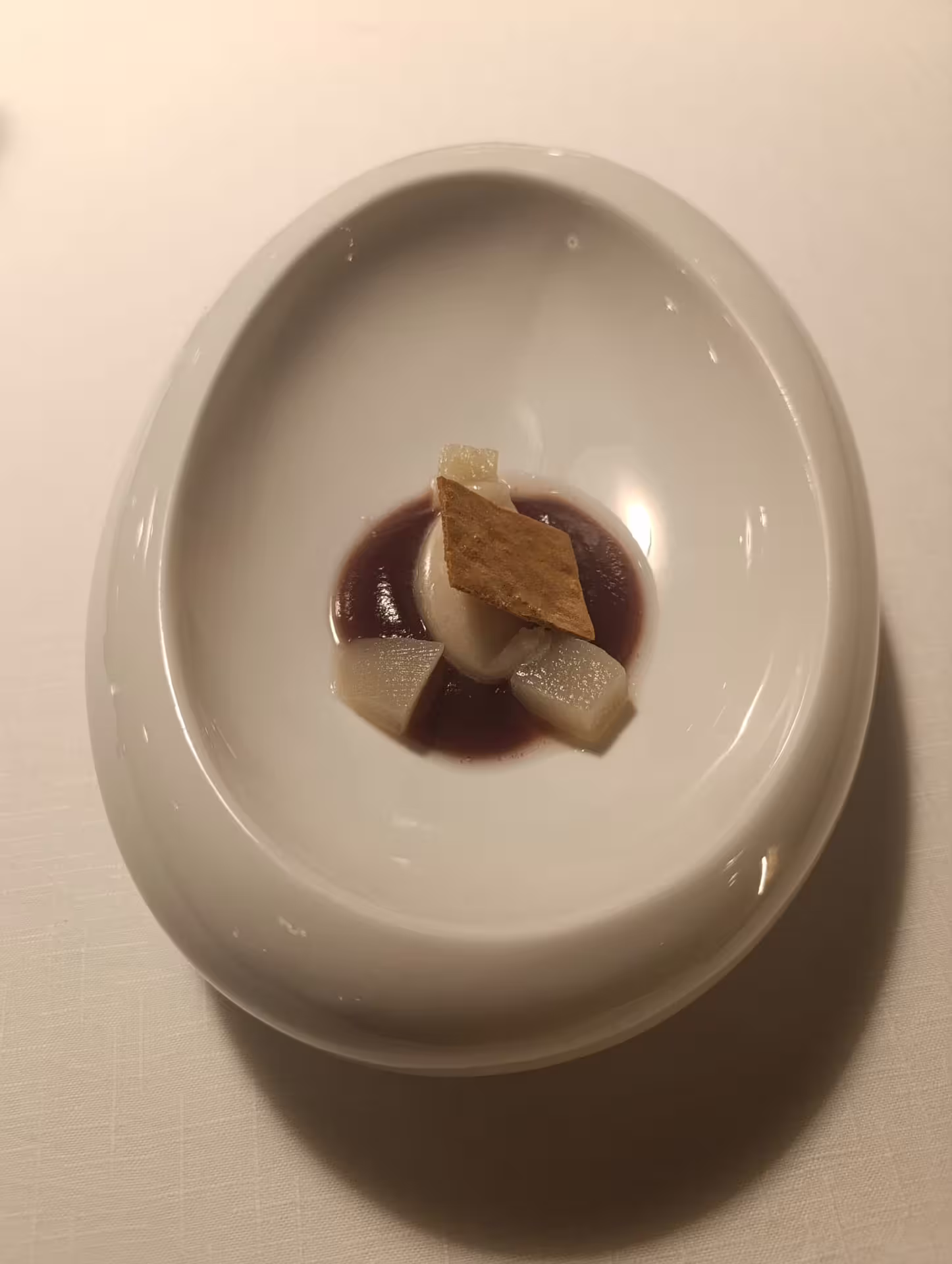 Gourmet dessert with delicate pear slices and sauce on Rioja wine experience, highlighting fine dining elegance.