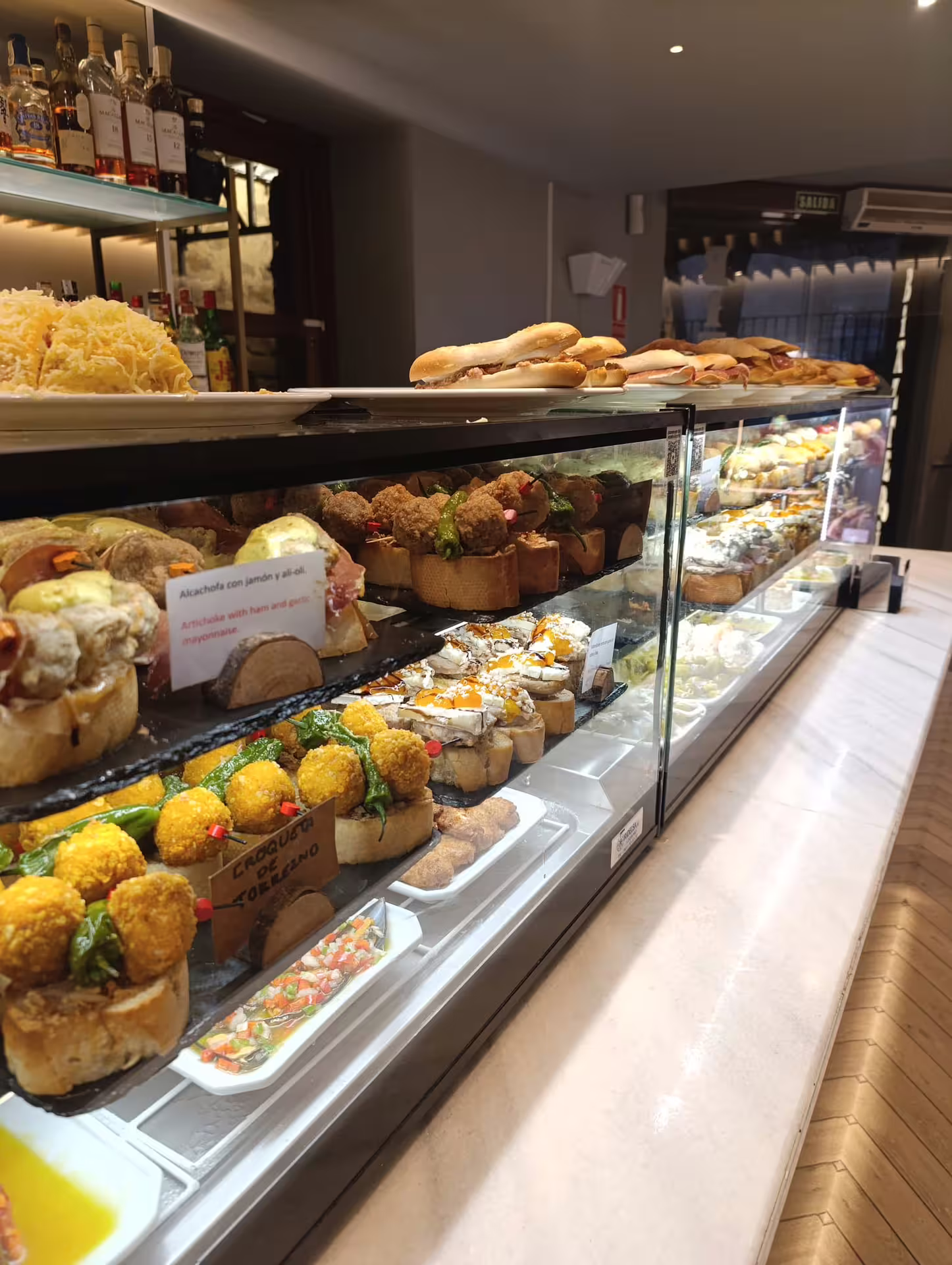Spanish tapas display in Rioja wine tour with diverse pintxos and local delights in a vibrant bar setting.