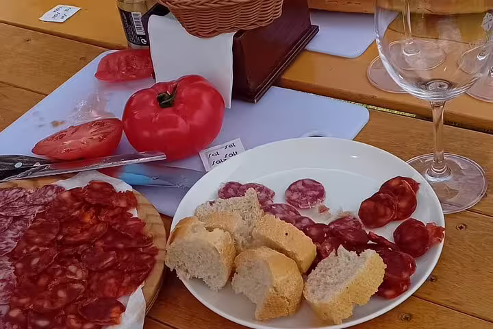 Delicious charcuterie with fresh bread and wine glass during Rioja winery tour tasting experience.