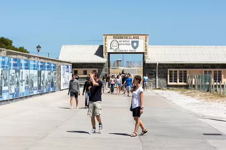 Tourists exploring the entrance of Robben Island, a significant historical site near Cape Town.