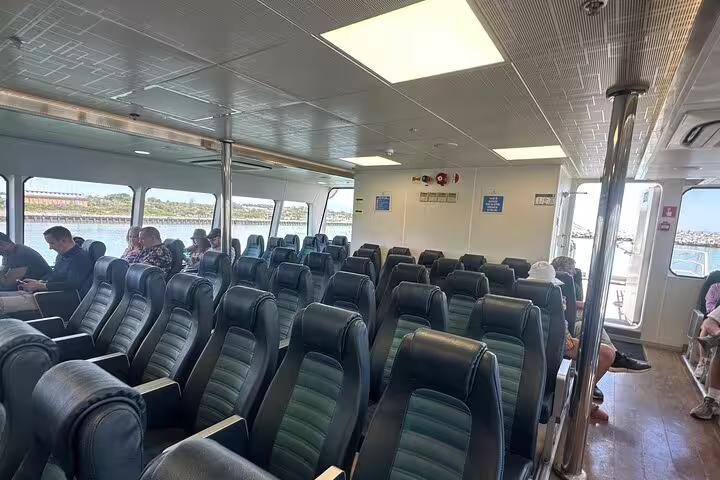 Interior view of ferry seating on the Robben Island tour, offering comfortable travel with scenic ocean views.