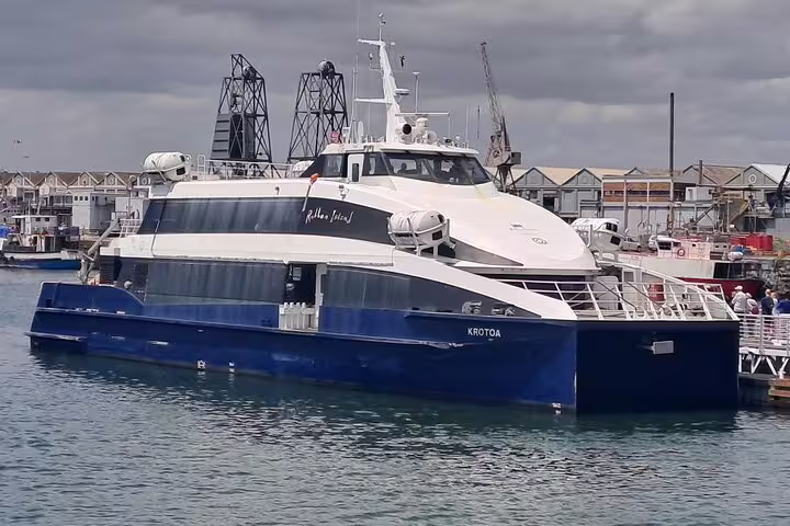Blue and white ferry vessel at the harbor ready for the Robben Island, Table Mountain, and Cape Point tour.