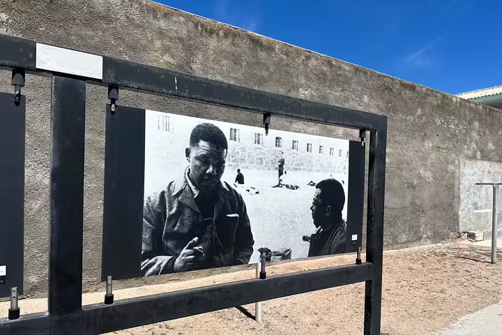 Outdoor display of historical photos at Robben Island, showcasing its significance during the half-day tour.