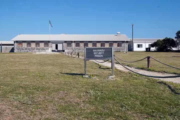 View of Robben Island's historical Maximum Security Prison building under a clear blue sky.
