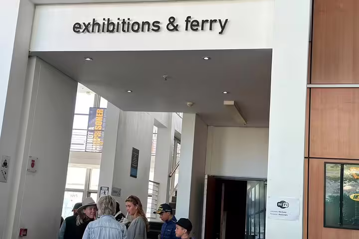 Tourists gather at the exhibitions and ferry entrance for the Robben Island half-day tour experience.