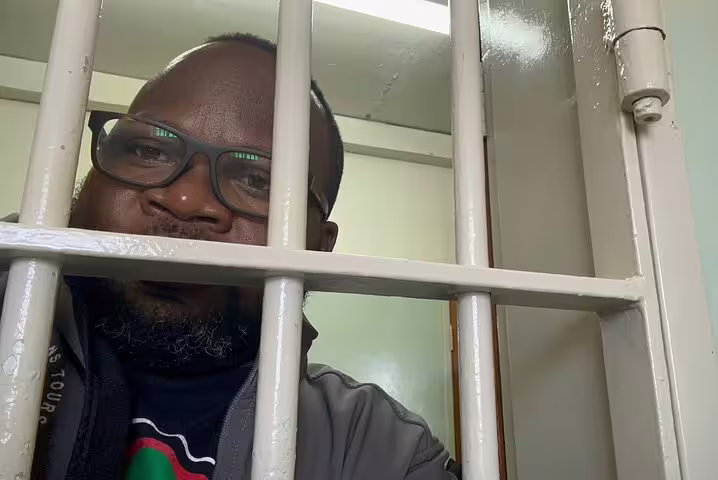Visitor inside a Robben Island prison cell experiencing the historical site during a half-day tour.