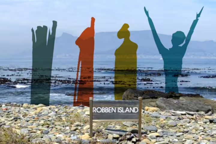 Robben Island shoreline with artistic figures and sign, a highlight of the 2-day Table Mountain and Cape Point tour.