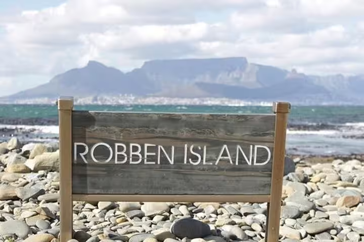 Robben Island sign with Table Mountain in the background, offering a scenic view on a guided full day tour.