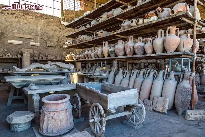 Shelves of Roman amphorae, artifacts and a wooden cart preserved in Pompeii, a highlight of the Sorrento Pompei Vesuvio tour