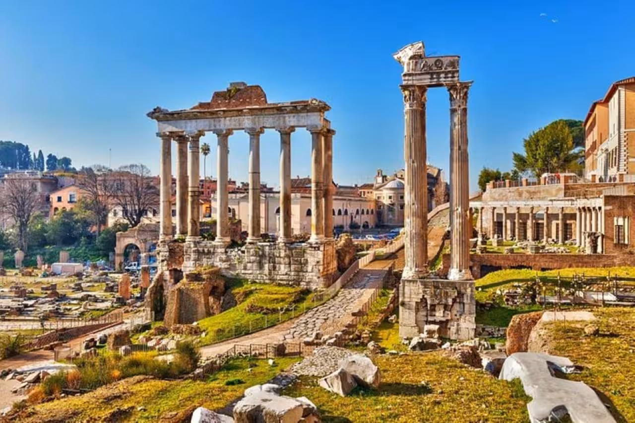 The Roman Forum's ancient ruins bask in sunlight, showcasing Rome's rich historical and architectural heritage.