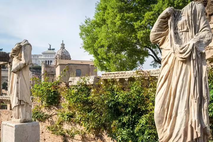 Headless marble statues and ancient walls in the Roman Forum, seen on a Colosseum and Palatine Hill guided tour in Rome