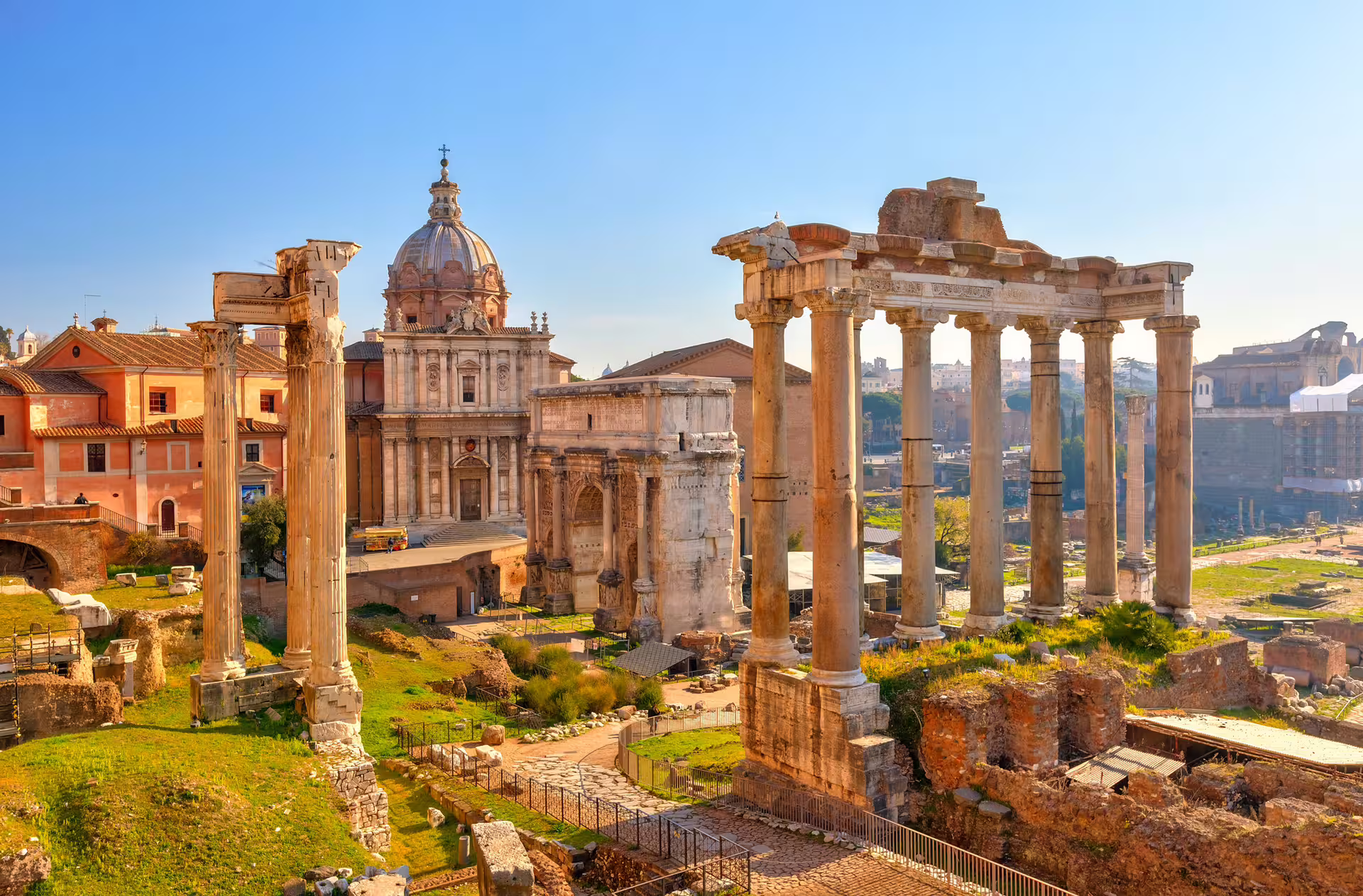 Sunlit Roman Forum ruins and historic churches in Rome, highlight of Mediterranean Passion 9‑day Italy self‑drive tour
