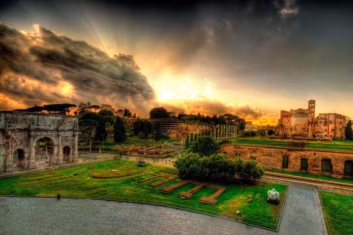 Stunning view of the Roman Forum and Palatine Hill at sunset, showcasing ancient ruins and lush greenery.