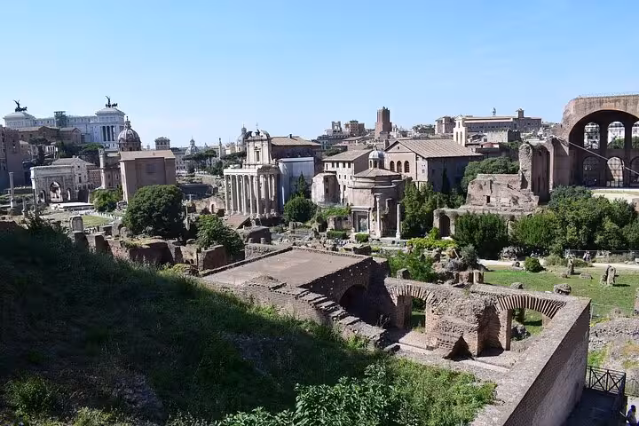 Panoramic view of the Roman Forum showcasing historical ruins and lush greenery in the heart of Rome.