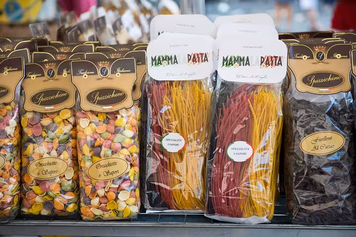 Colorful Italian pasta varieties displayed in packaging at a Roman market, ideal for a foodies tour.