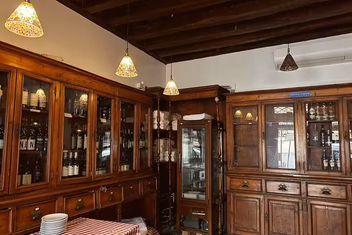 Cozy Roman kitchen with rustic wooden cabinets, ideal for a pasta cooking class in Rome city center.