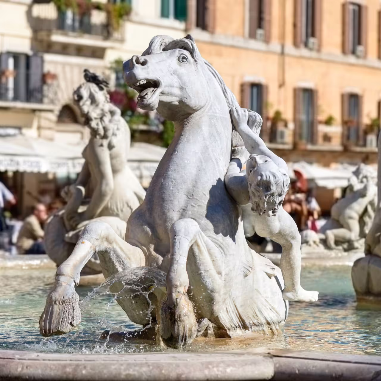 Intricate marble sculpture of horses and figures in a famous Roman fountain, capturing the city's artistic heritage.