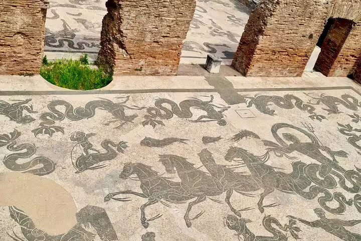 Detailed black and white Roman mosaics of sea creatures at Ostia Antica seen on exclusive river cruise and guided tour from Rome