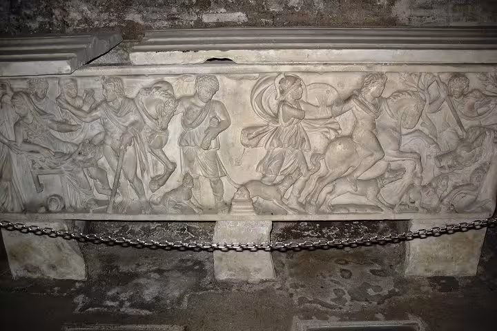 Carved Roman sarcophagus with detailed mythological reliefs in the subterranean ruins of San Clemente Basilica, Rome