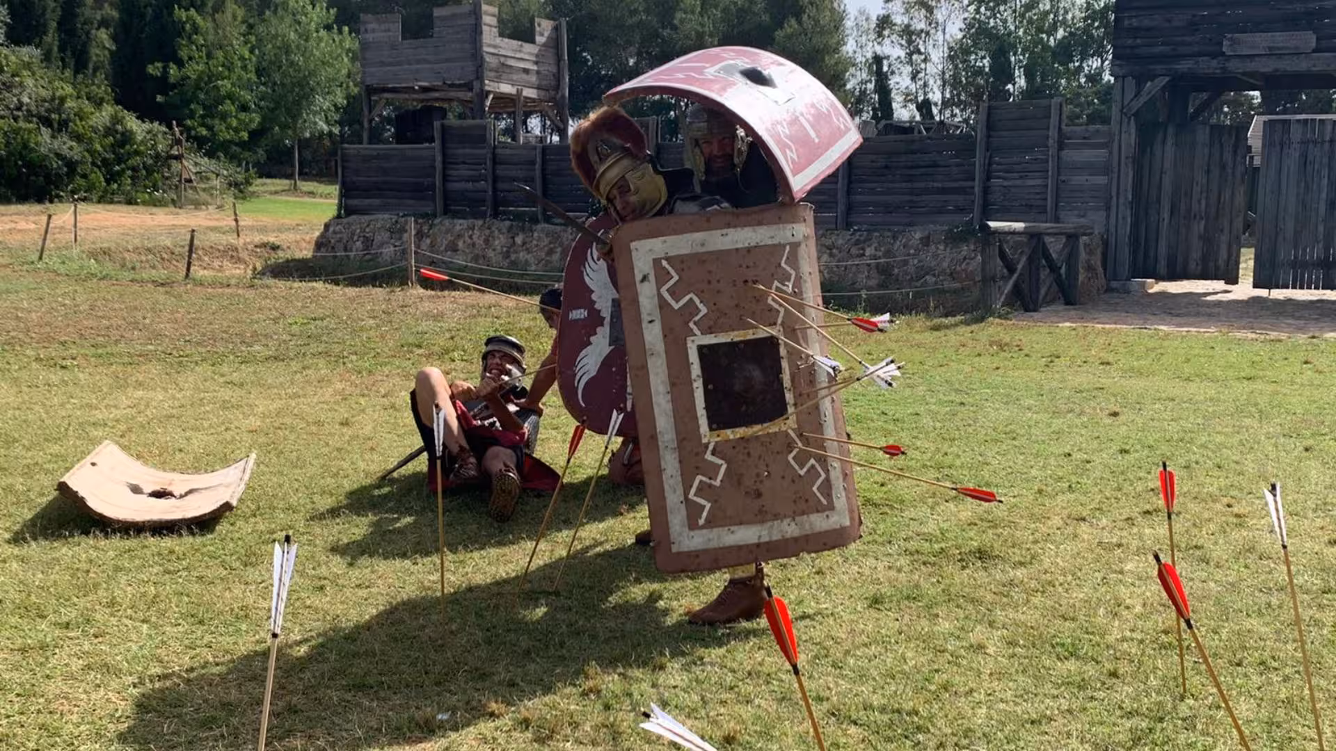 Roman soldiers in authentic gear demonstrating battle tactics at Sassari's Roman Castrum, enriching historical tours.