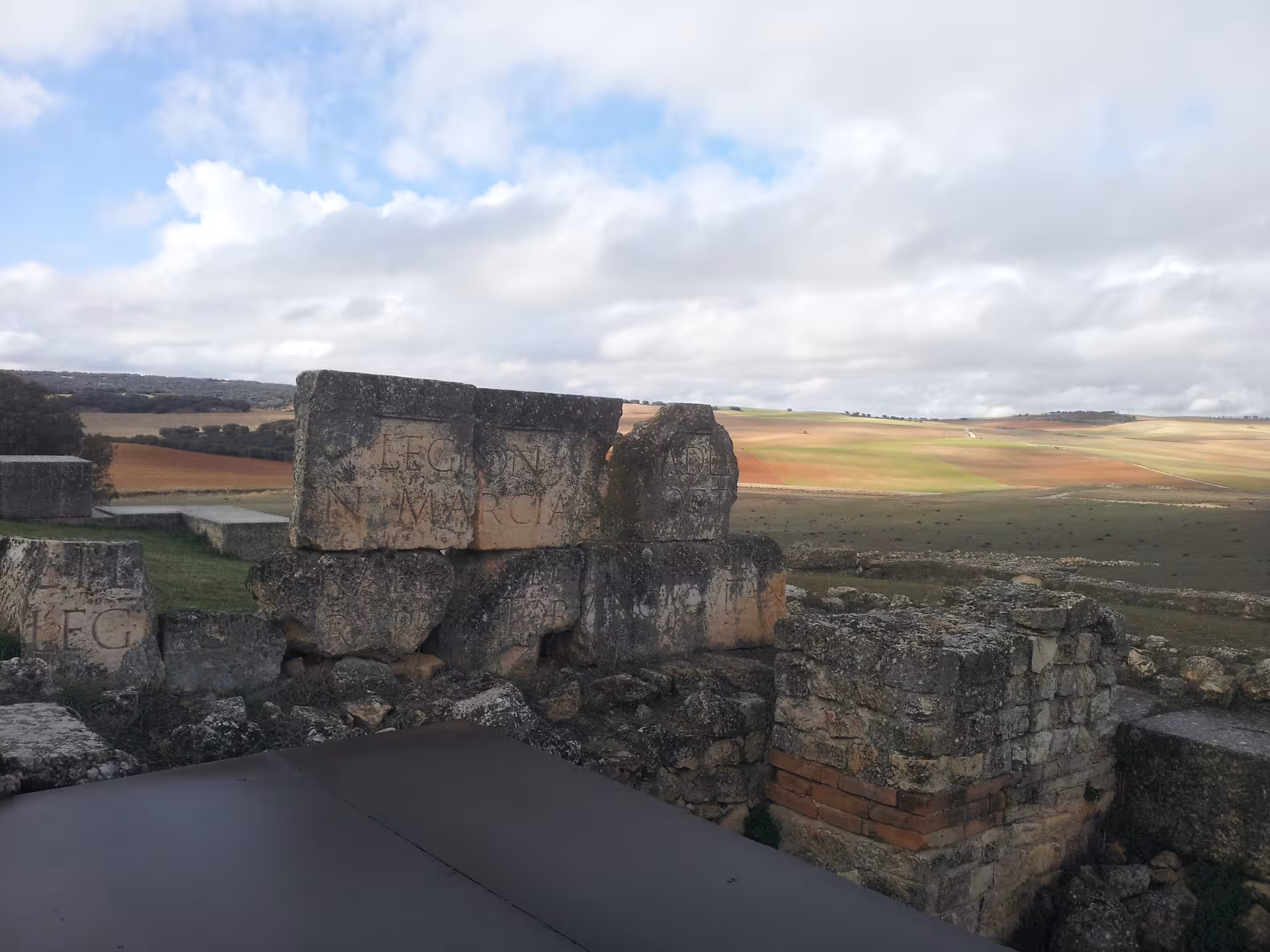 Ancient Roman stone inscription at Segóbriga archaeological park, must-see on one day Roman Empire tour from Madrid