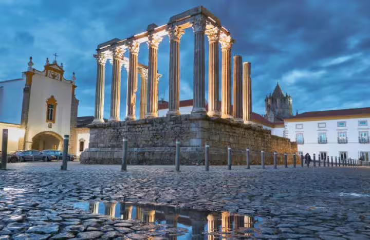 Visit the illuminated Roman Temple of Évora at night during your customized Lisbon to Algarve transfer.
