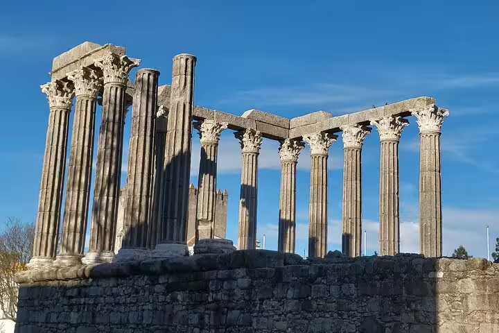 Ancient Roman Temple ruins in Évora under blue skies, featured in a private day tour to Évora and Monsaraz with guide.